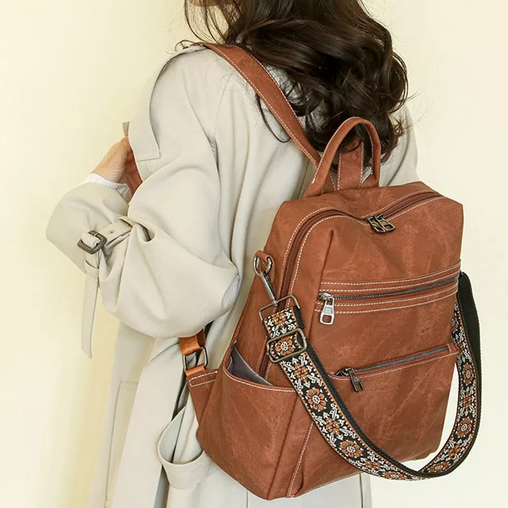 Sac à dos en cuir vintage marron avec plusieurs poches zippées et bandoulière réglable