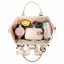 Mini sac à dos Plume Claire beige avec poches et accent rose
