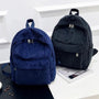 Sac à dos fille en velours côtelé navy et noir avec poignée, zippers et poche avant