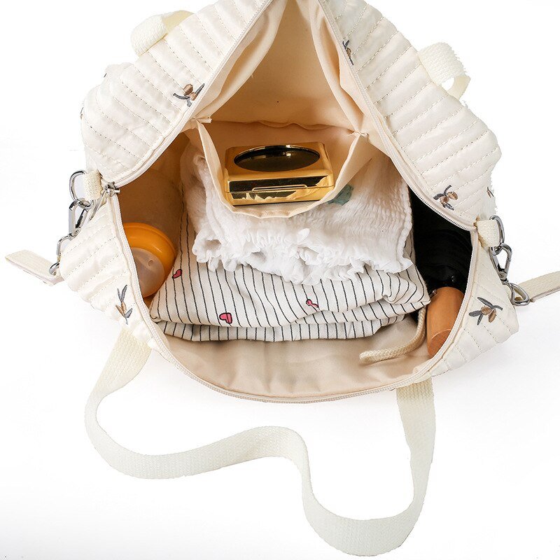 Sac à bandoulière en coton pour bébé avec sac de voyage crème et broderie olivier