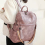 Sac à dos cuir souple poussière rose avec pompon et bandoulière rayée