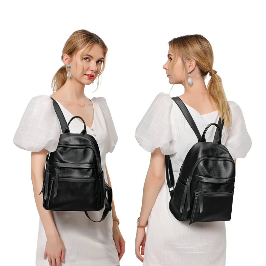 Sac à dos femme de ville en cuir noir avec poche zippée avant et pompons latéraux