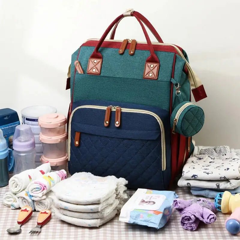 Sac à dos à langer 20L multipoches en teal, navy et bordeaux avec accents matelassés