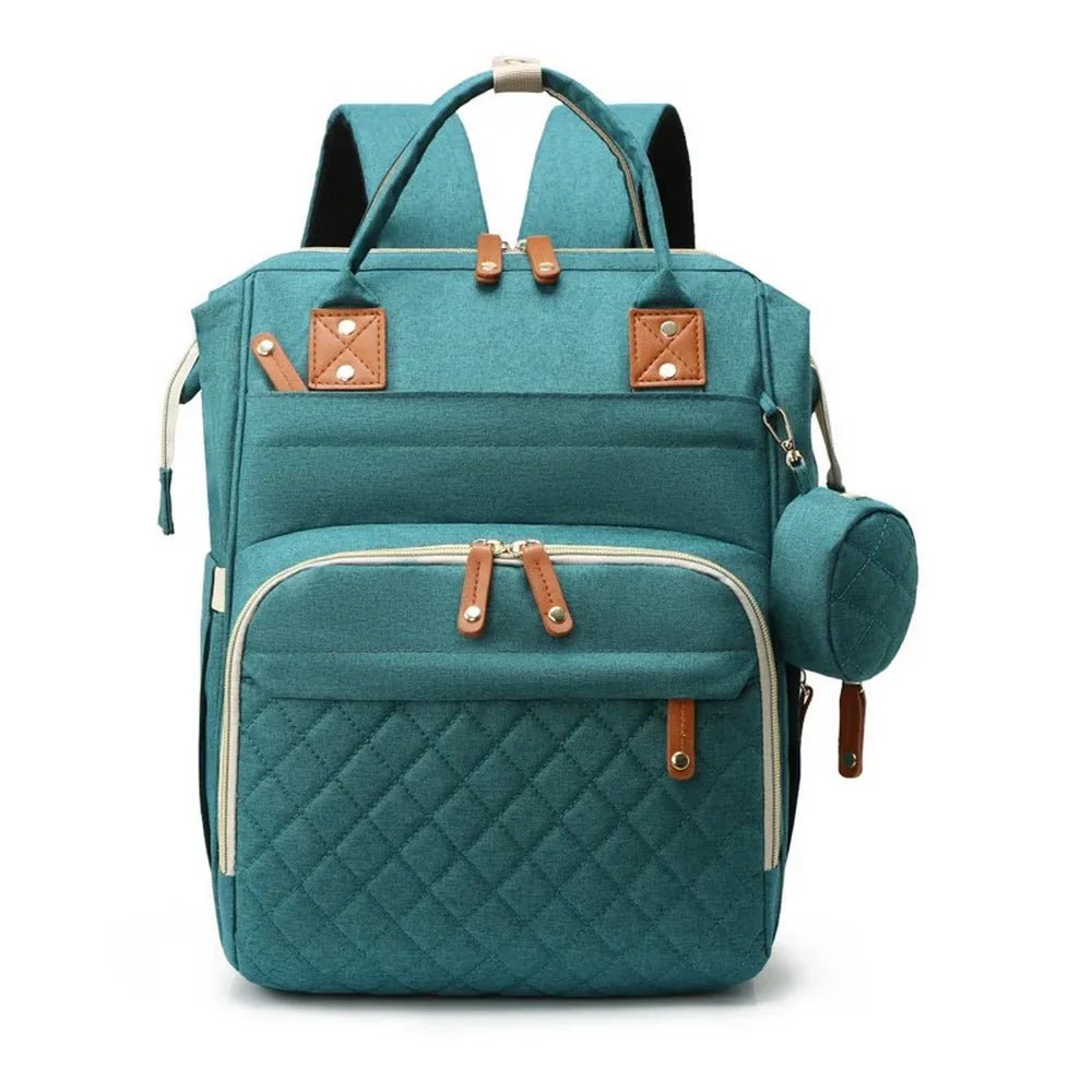 Sac à dos à langer 20L multipoches en tissu teal avec accents en faux cuir marron et petite pochette assortie