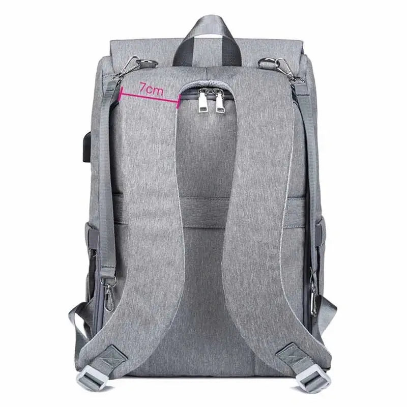Sac à dos à langer ergonomique gris avec bretelles ajustables et poignée supérieure