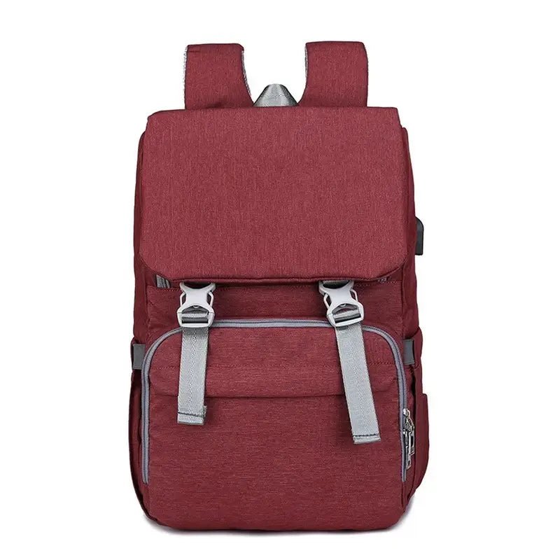 Sac à dos à langer ergonomique en tissu marron avec bretelles grises et boucles
