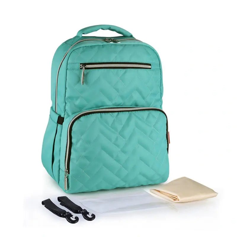 Sac à dos à langer isotherme turquoise avec poches, poignée, bretelles, et tapis à langer beige
