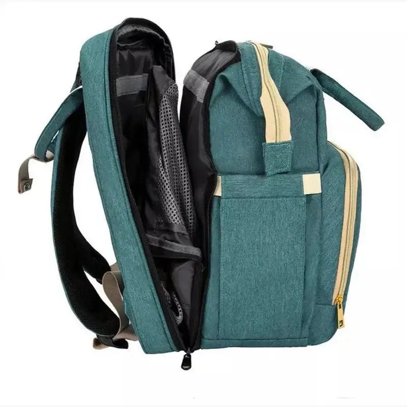 Sac à dos à langer lit en vert teal avec accents beige et plusieurs compartiments