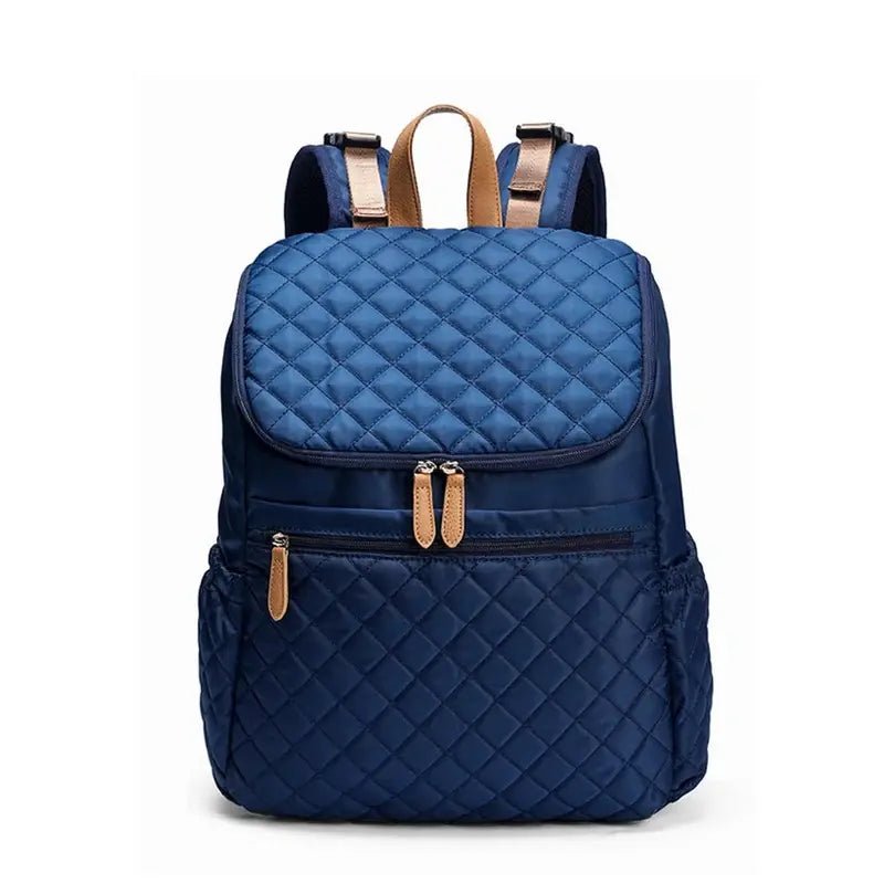 Sac à dos à langer noir avec motif matelassé bleu marine et accents tan élégants