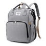 Sac à dos à langer USB en toile gris clair avec plusieurs compartiments et poignée supérieure
