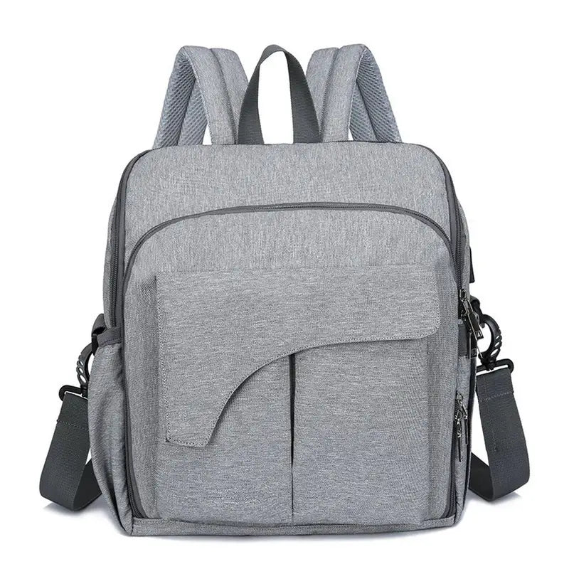 Sac à langer pour bébé en tissu gris clair à poches extérieures et bandoulière convertible